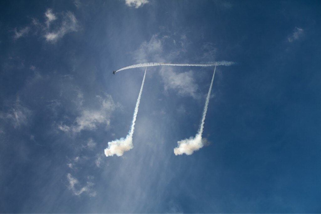 Skywriting plane drawing music notes