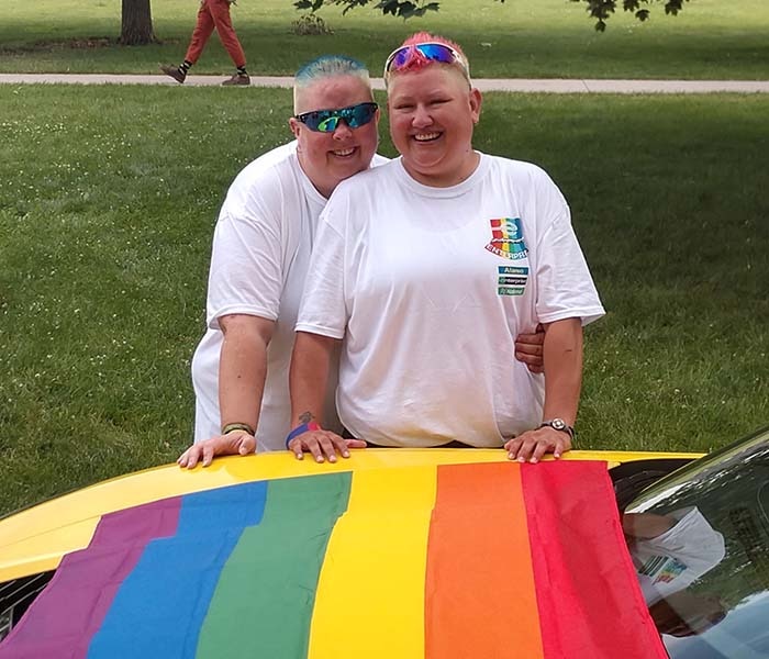Amy and Ace with the PRIDE flag