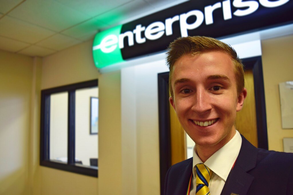 Selfie of James in front of Enterprise sign