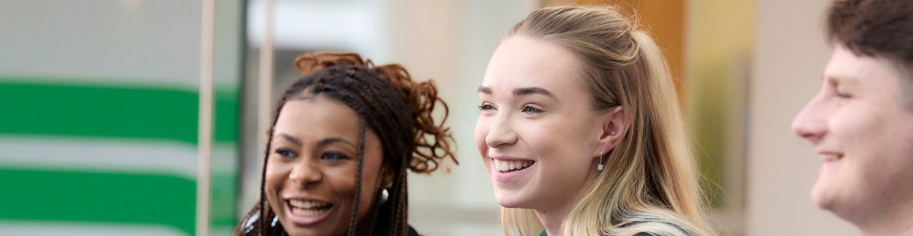 Enterprise Mobility team members smiling and discussing their apprenticeship training.