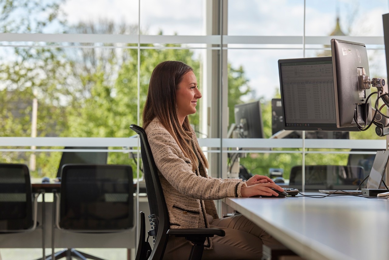 Enterprise Mobility team member working at a computer in an office.