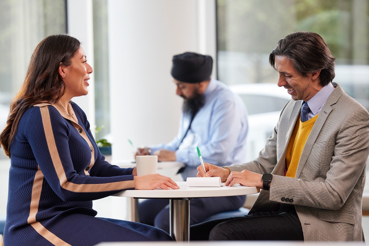 Employees having a meeting over coffee  