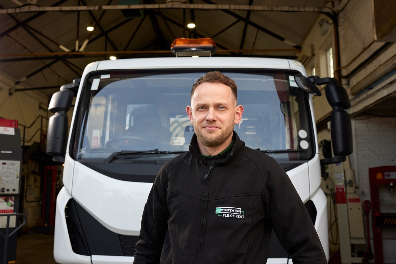 Enterprise Mobility team member standing in front of a van.