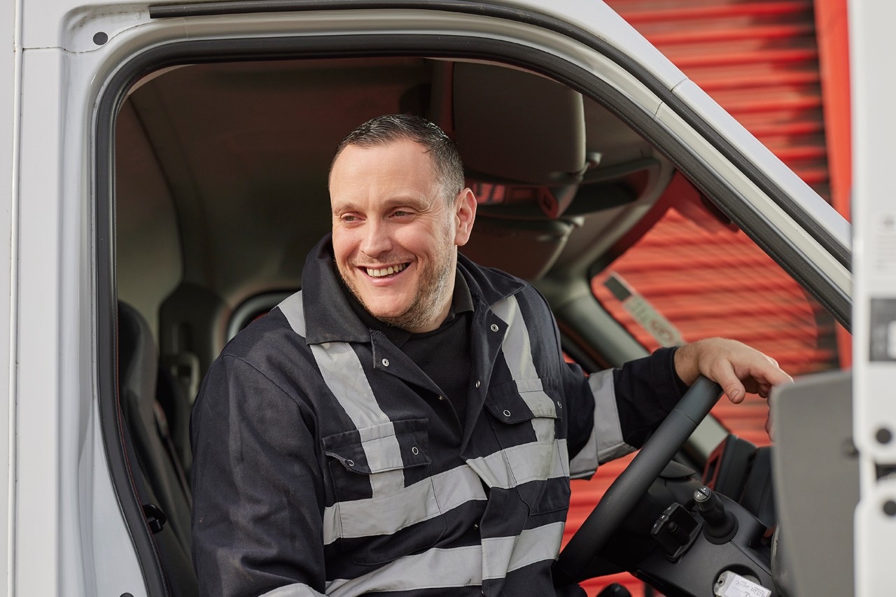 Enterprise Mobility Mechanic stepping out of a van. 