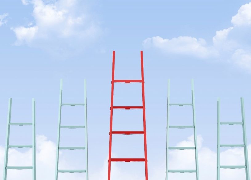 Five ladders with a taller red one in the middle on a sky background