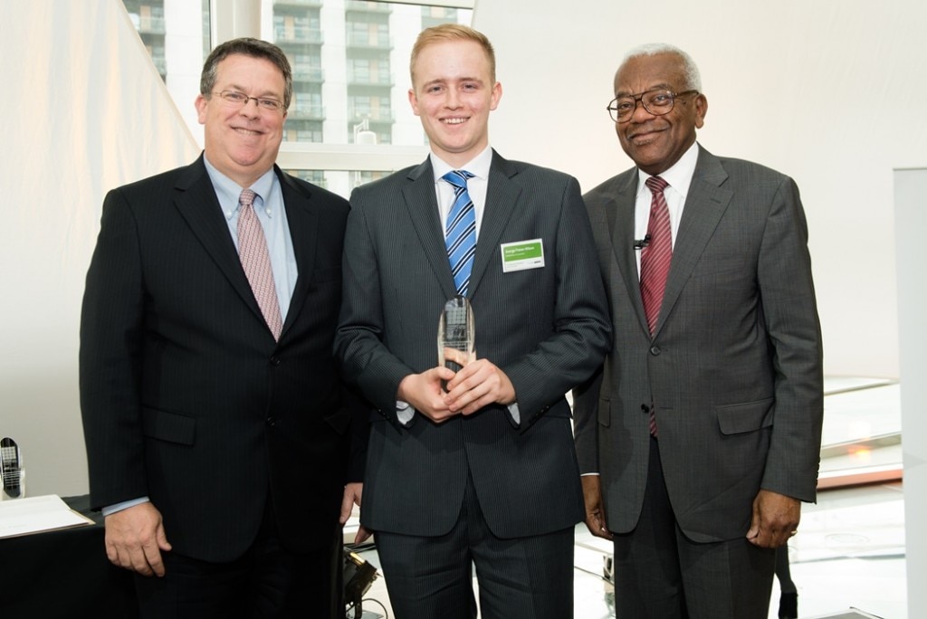 George Fisher-Wilson receiving an award from two men