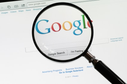 Magnifying glass over Google homepage 