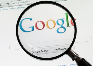 Magnifying glass over Google homepage 