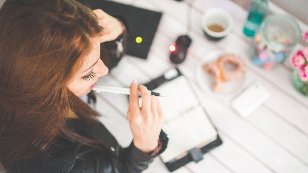 Woman pondering things at her desk