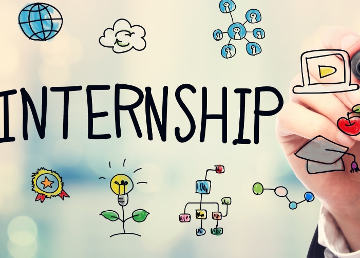 Hand drawing icons on glass around the word "internship"