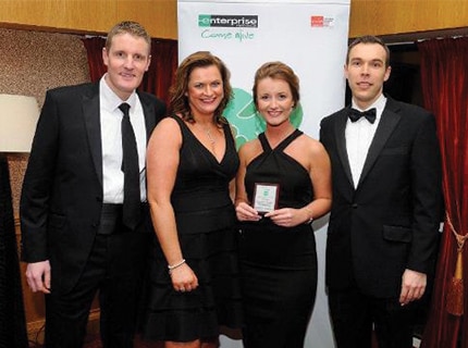 Student with her family as she receives intern of the year award