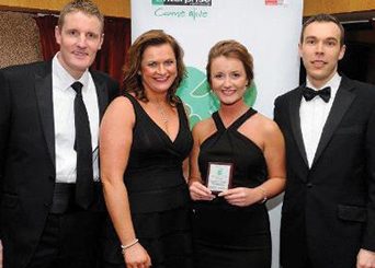 Student with her family as she receives intern of the year award