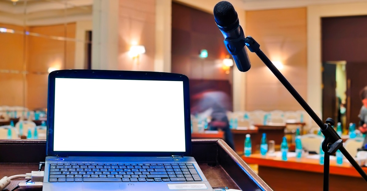 Laptop and microphone at a podium