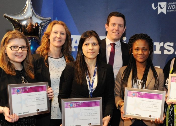 Group of students holding awards