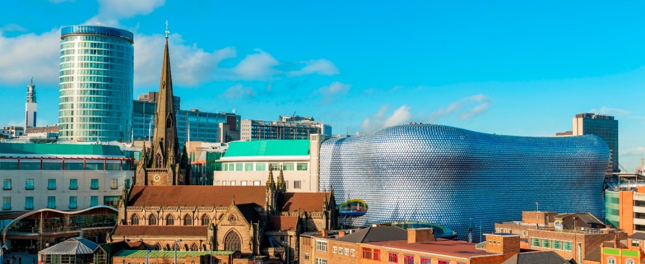 Photo of a city with a church and some interestingly shaped buildings