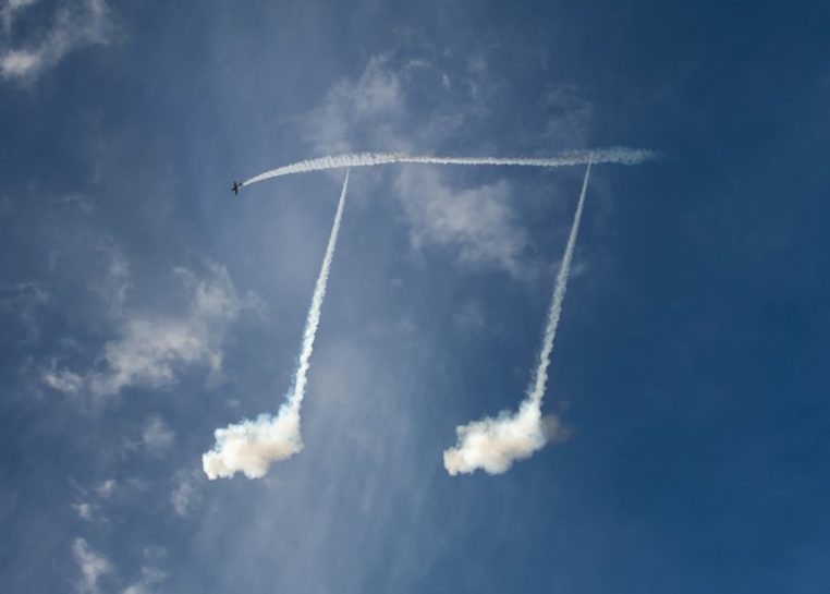 Skywriting plane drawing music notes