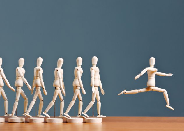Wooden people figurines in progression from walking to leaping