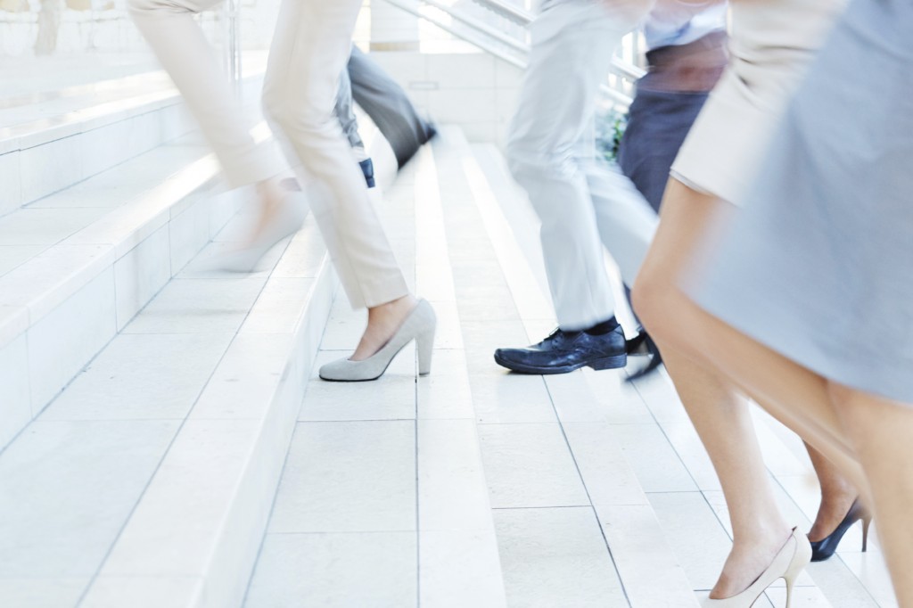 People running up stairs in business attire