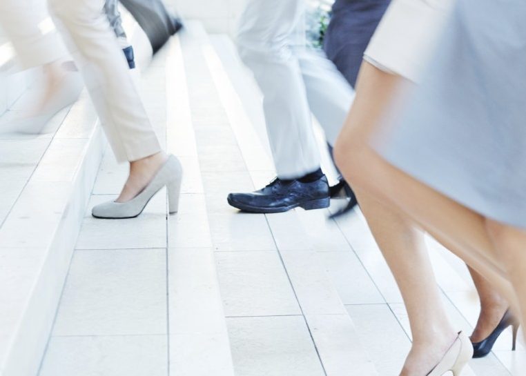 People running up stairs in business attire