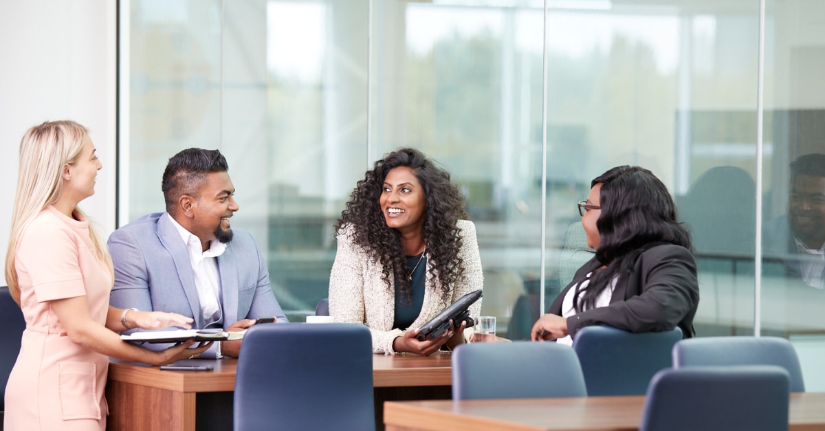 Colleagues sitting at a table talking