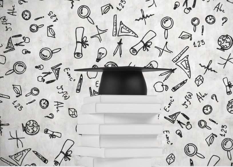 Graduation cap on stack of books with school related icons in the background