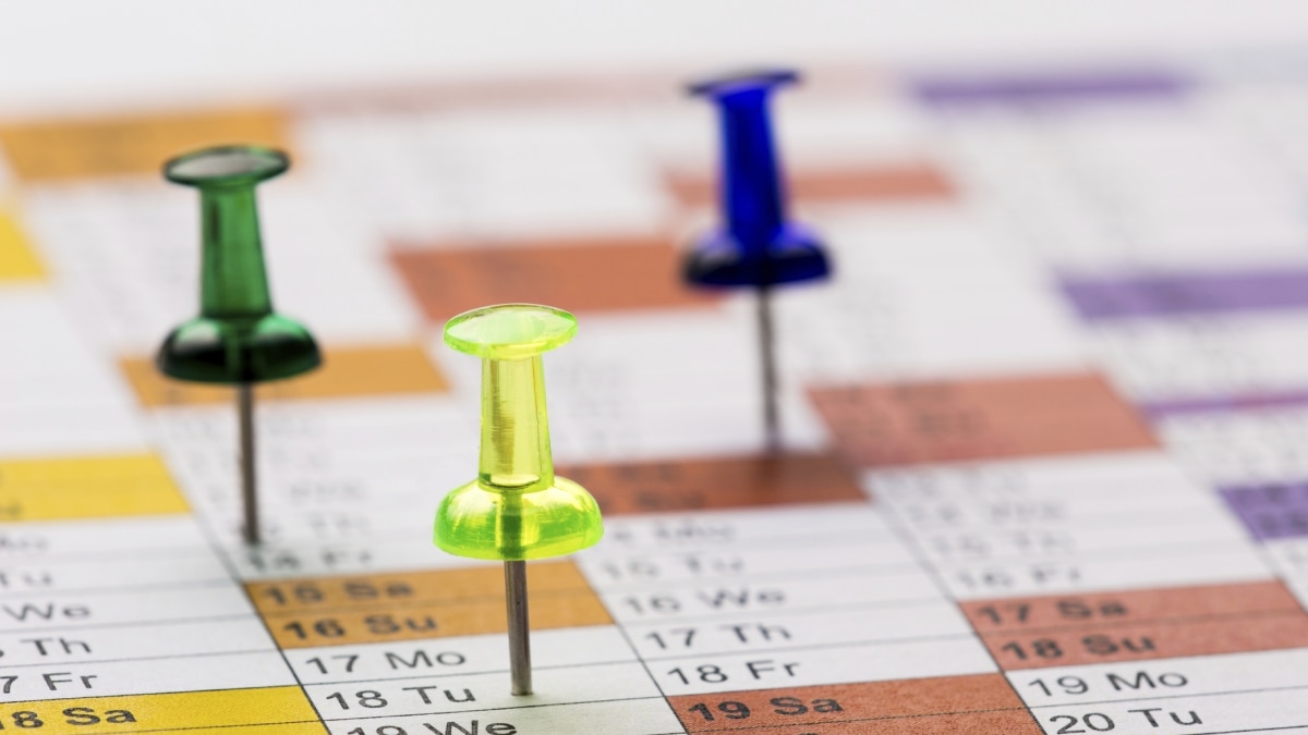 Push pins on a calendar