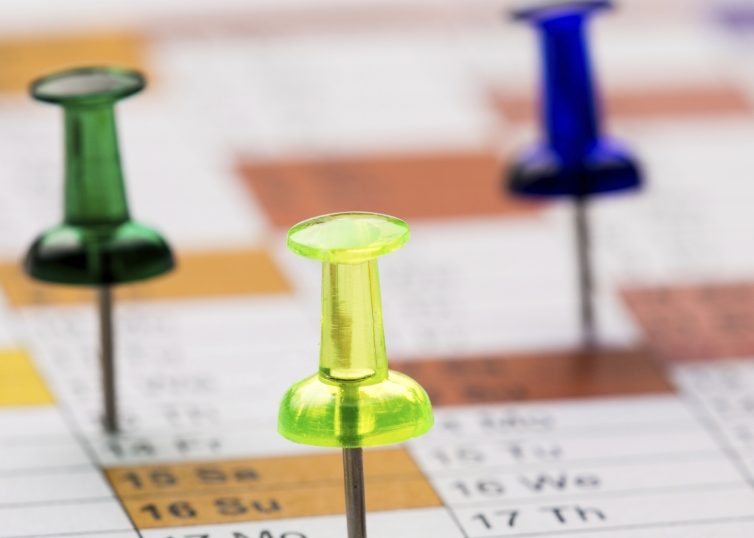 Push pins on a calendar
