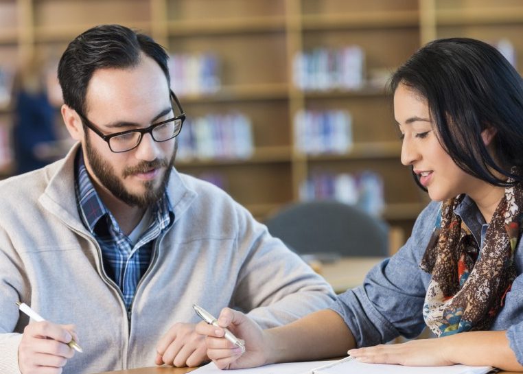 Students reviewing notes in a library