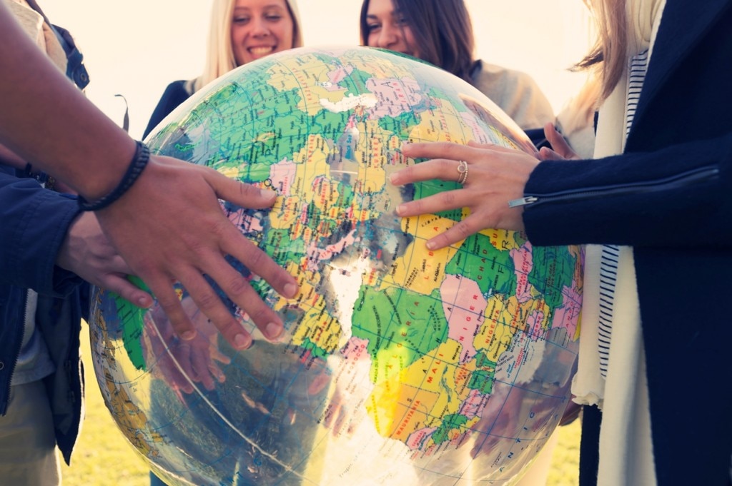 People holding a globe beach ball