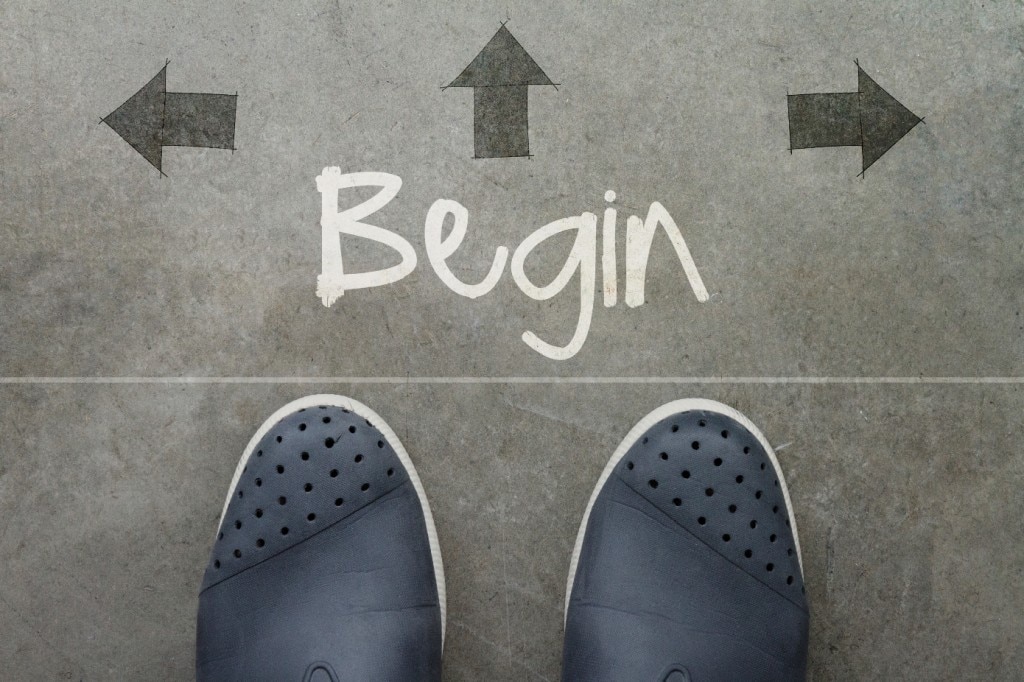 Feet on ground with "Begin" written surrounded by arrows