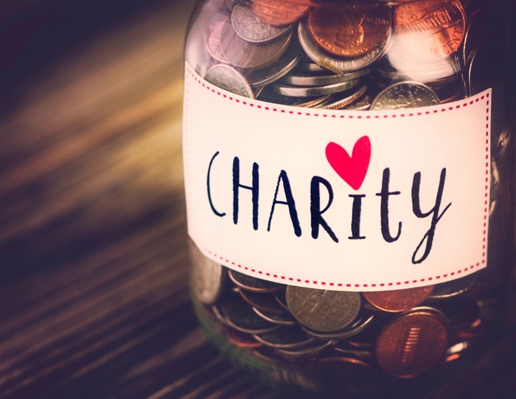 Jar of coins that says "Charity"