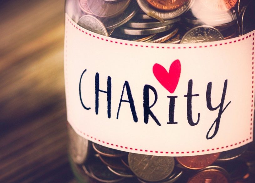 Jar of coins that says "Charity"