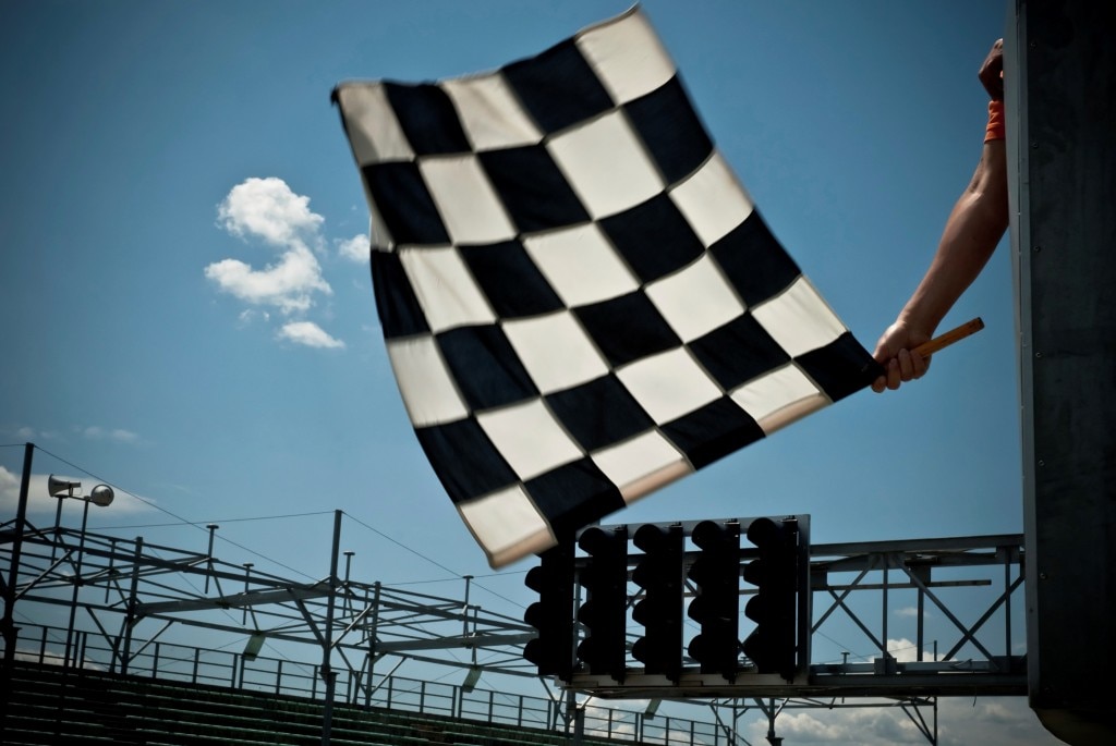 Checkered flag dropping at a racetrack