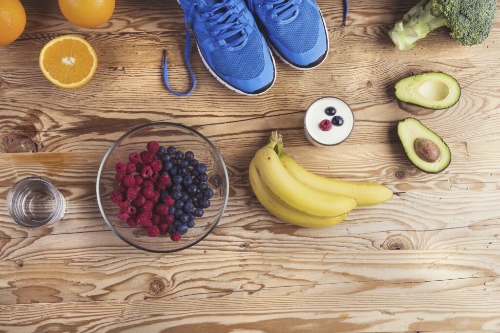 Running shoes set out by fruits and vegetables