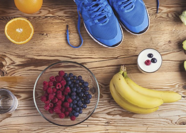 Running shoes set out by fruits and vegetables