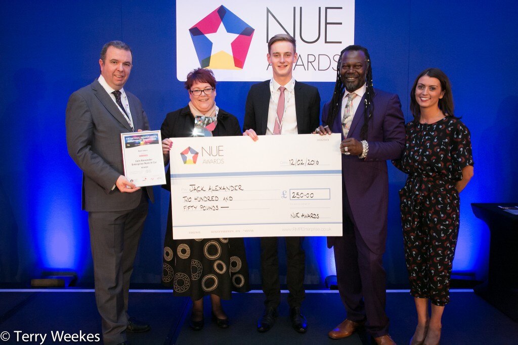 Jack Alexander being presented a vanity check by four professionals at the NUE awards