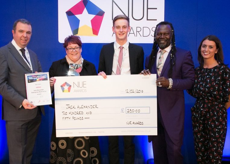Jack Alexander being presented a vanity check by four professionals at the NUE awards