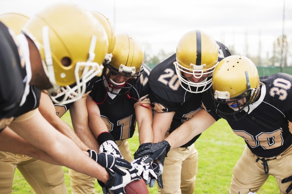 American football team in a huddle