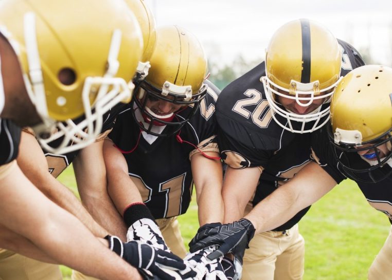 American football team in a huddle
