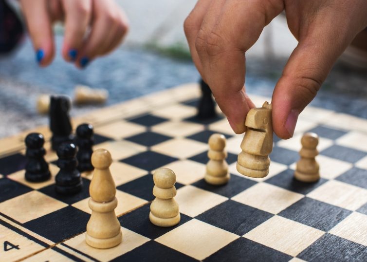 Chess board with two hands playing