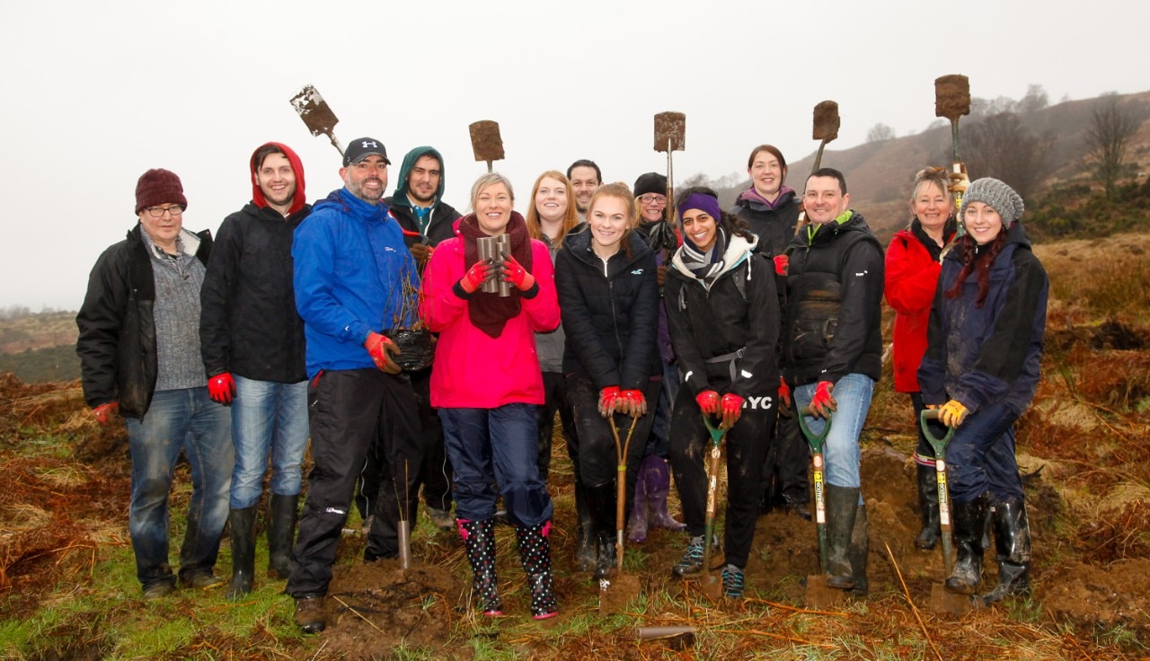 Enterprise employees with shovels after planting trees
