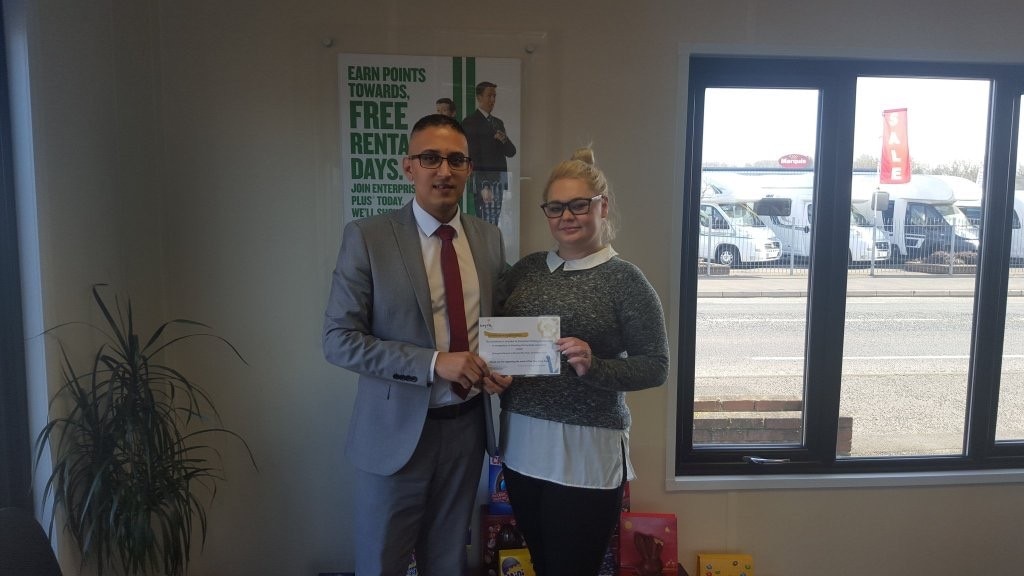 Rachael Riley receiving an award from an Enterprise employee
