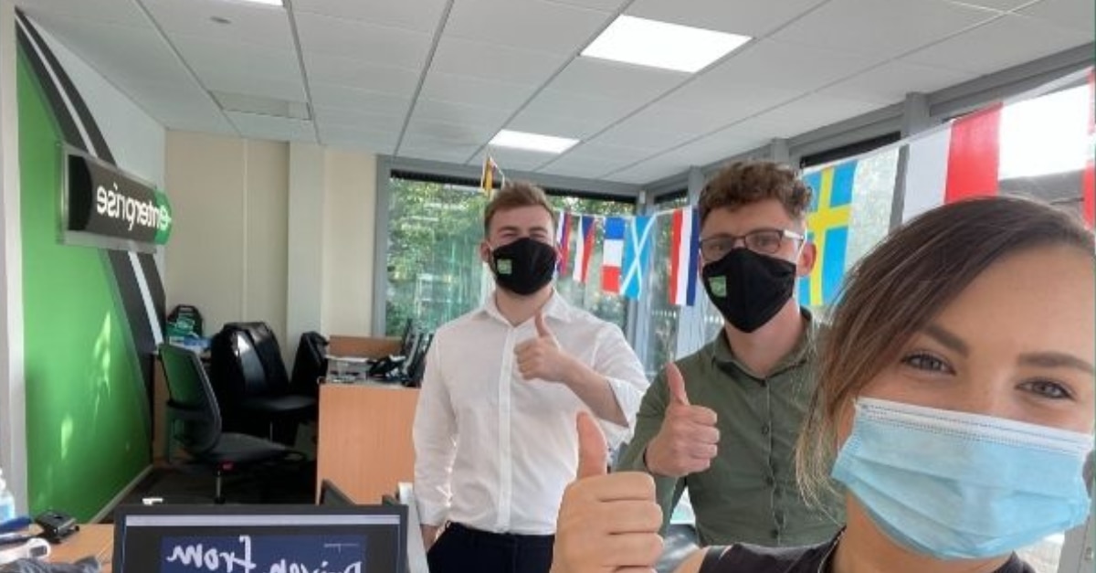 Enterprise employees wearing masks in the office for a selfie