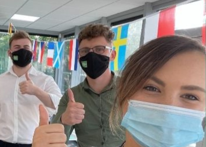 Enterprise employees wearing masks in the office for a selfie