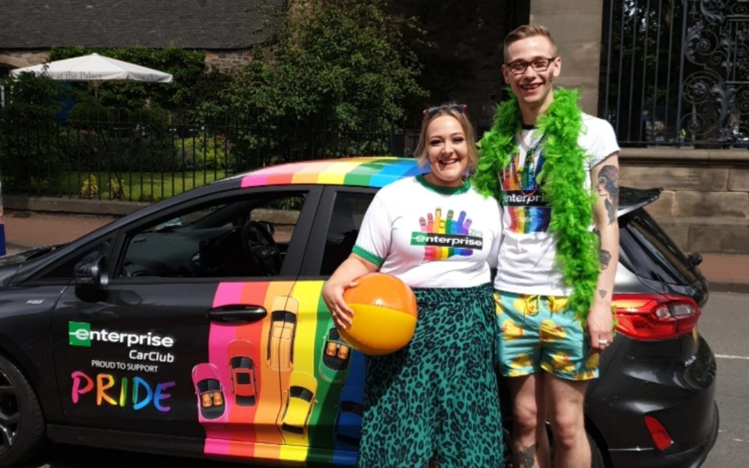 Dylan with another Enterprise employee at a PRIDE event with the Enterprise PRIDE car