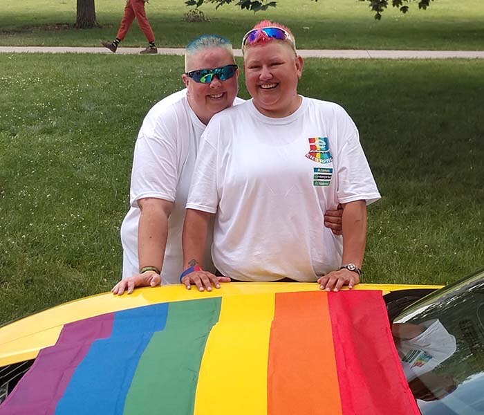 Amy and Ace with the PRIDE flag