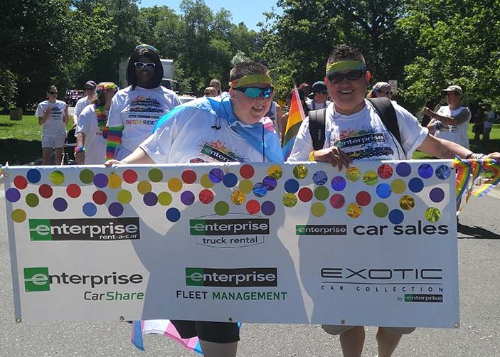 Amy and Ace walking in a parade with the Enterprise banner