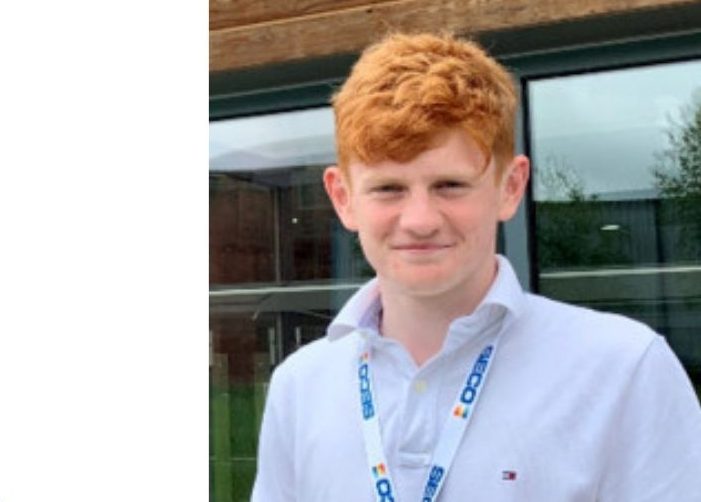 Flynn wearing a collared shirt with a lanyard accompanied by a quote on a white background