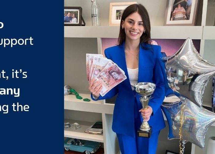 Sophie holding a trophy, money, and balloons with a quote