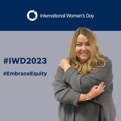 Leigh embrassing herself on #IWD2023 background